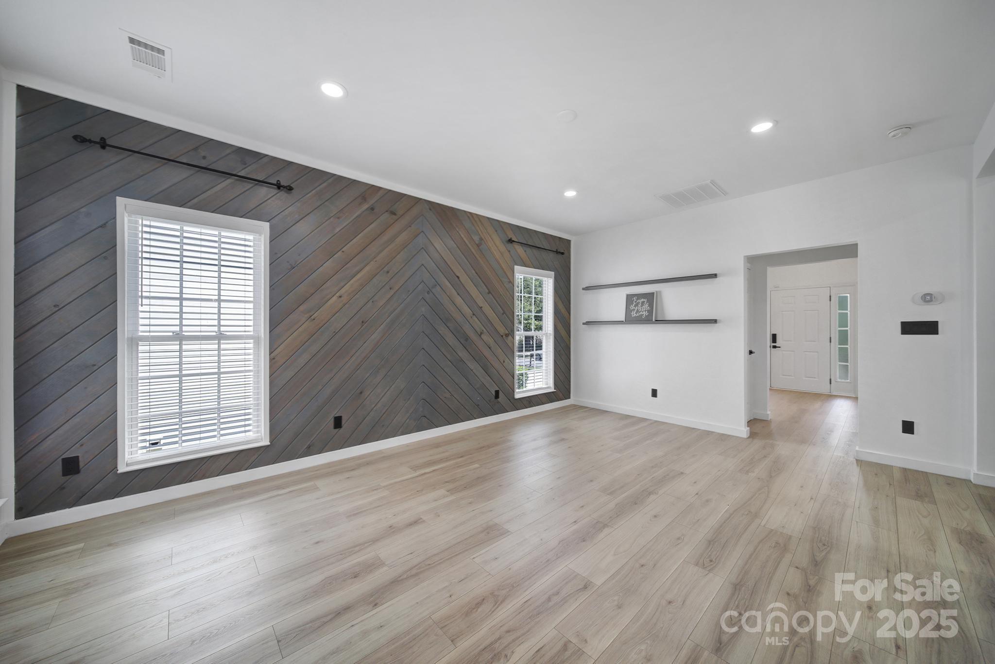 13425 Meadowmere Road Huntersville, NC 28078 - Photo 8 of 41 an empty room with wooden floor and windows