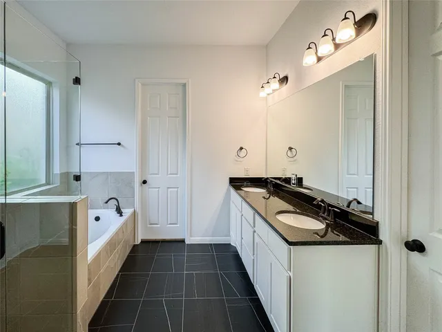 a kitchen with white cabinets and appliances
