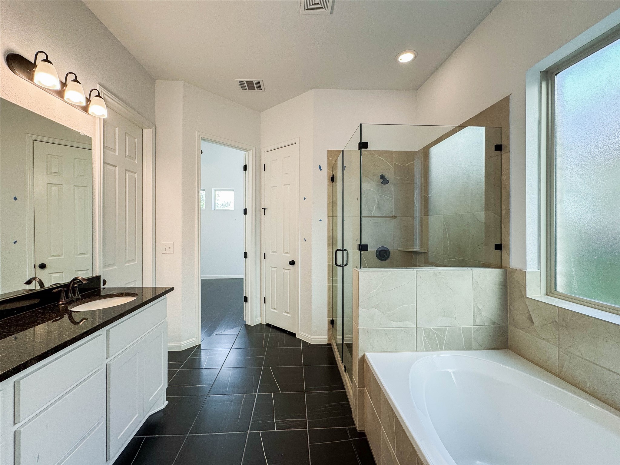 3810 Brushy Creek Road, Unit 73 Cedar Park, TX 78613 - Photo 20 of 42 a spacious bathroom with a granite countertop tub sink and shower