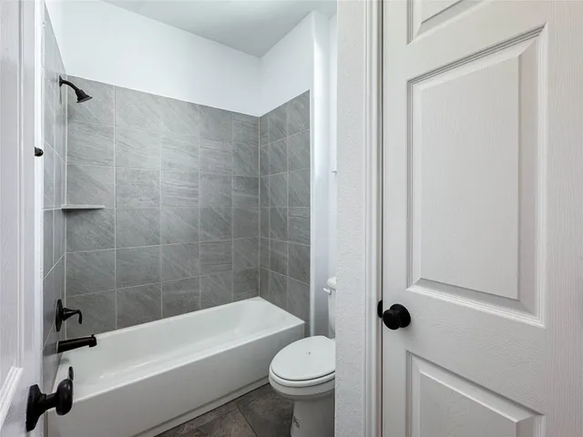 a bathroom with a bathtub and a toilet