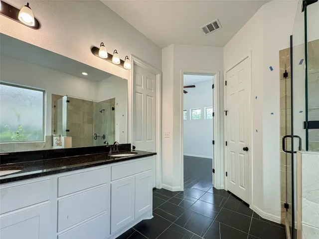 a bathroom with a double vanity sink and a mirror