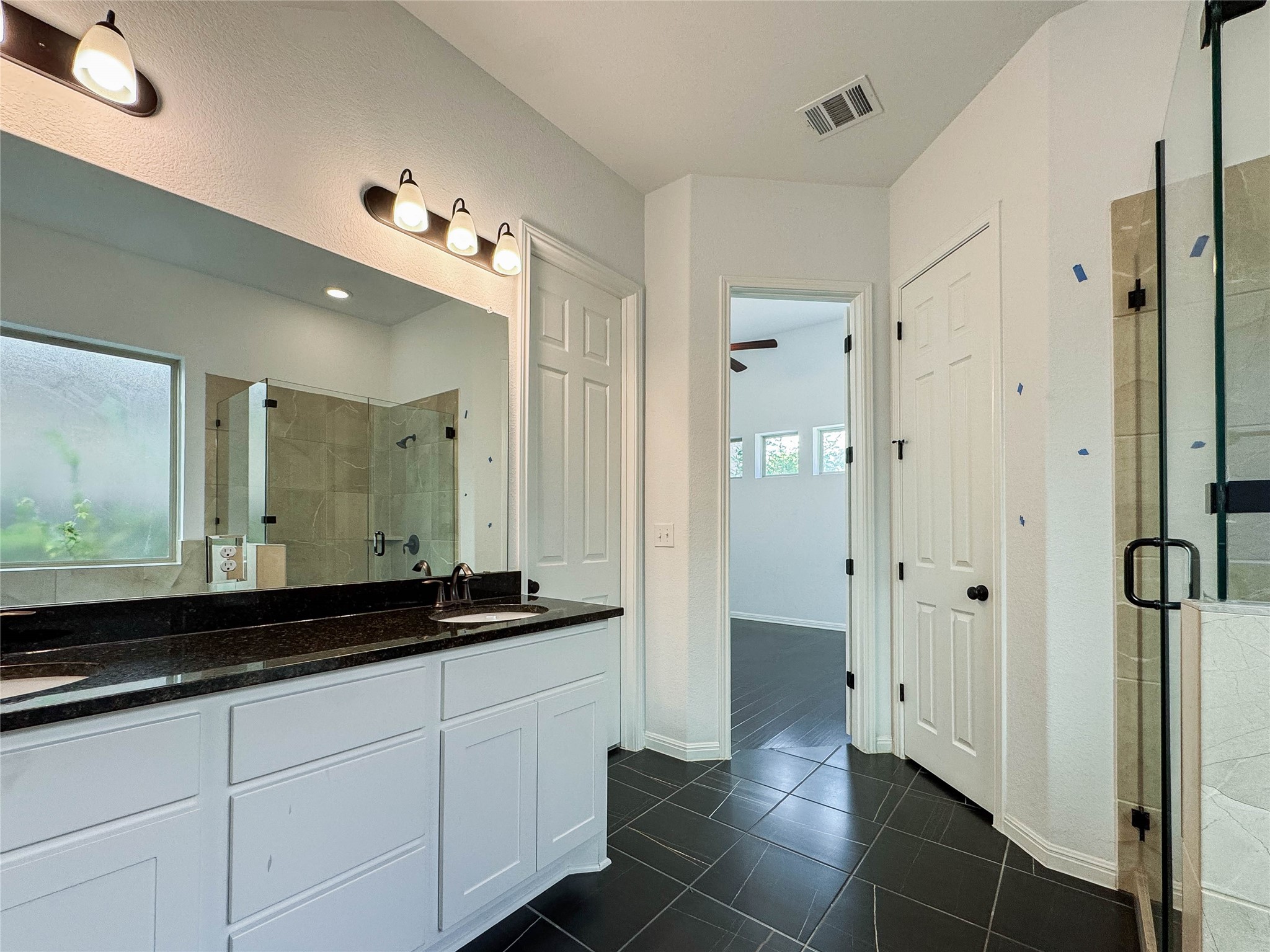 3810 Brushy Creek Road, Unit 73 Cedar Park, TX 78613 - Photo 33 of 42 a bathroom with a double vanity sink and a mirror