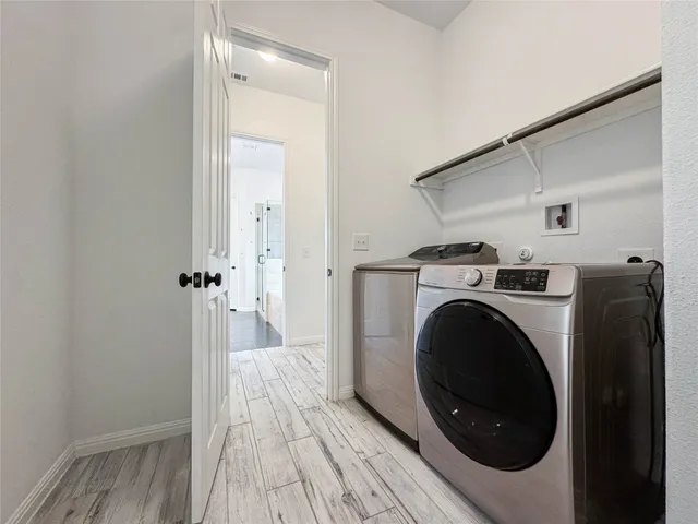 a view of a hallway with washer and dryer