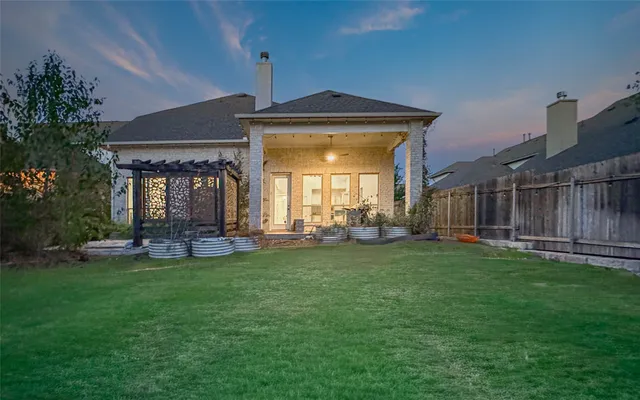 a front view of a house with swimming pool having outdoor seating