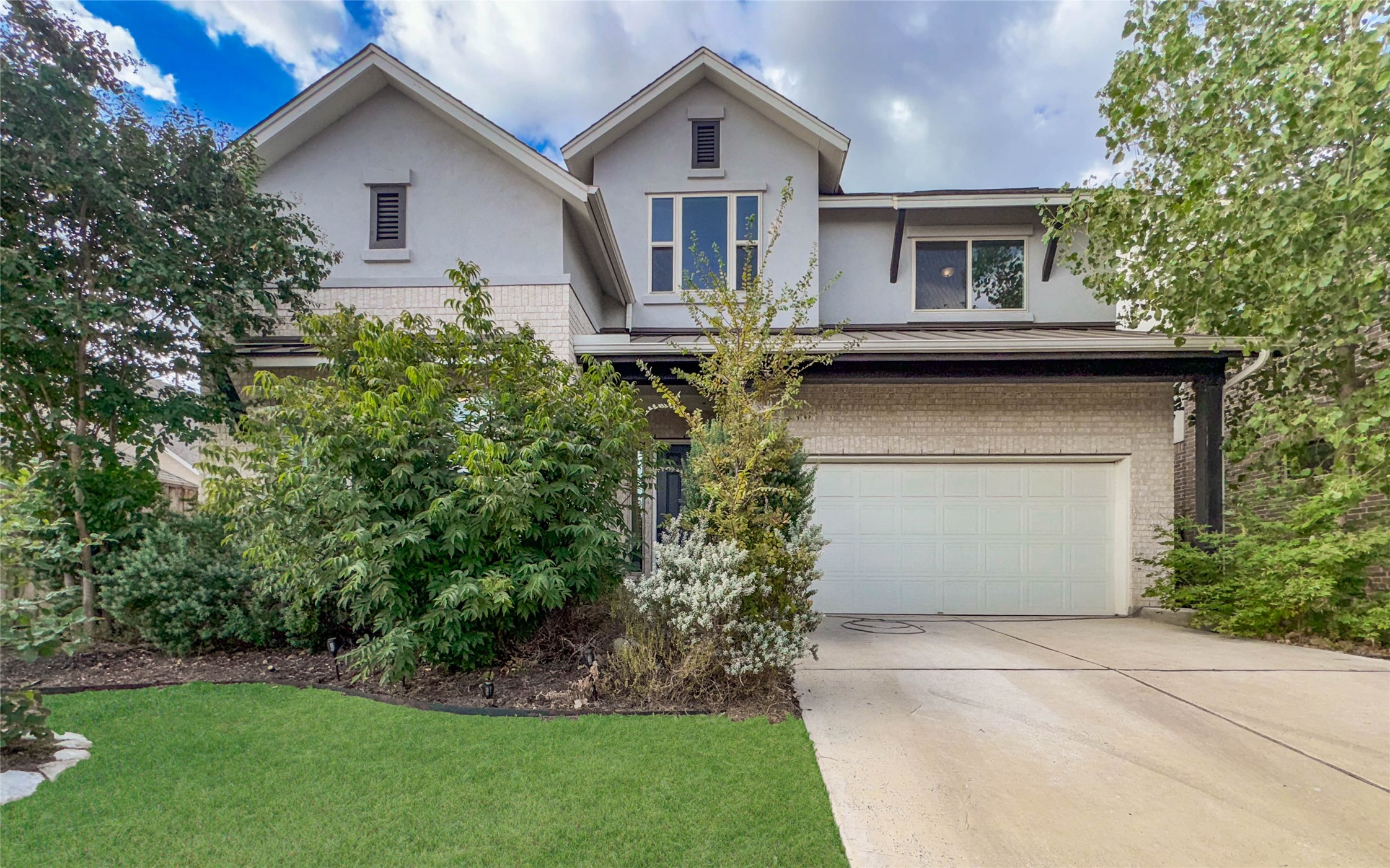 3810 Brushy Creek Road, Unit 73 Cedar Park, TX 78613 - Photo 5 of 42 a front view of a house with a yard and trees