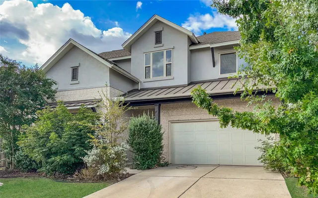 a view of a house with a yard and plants