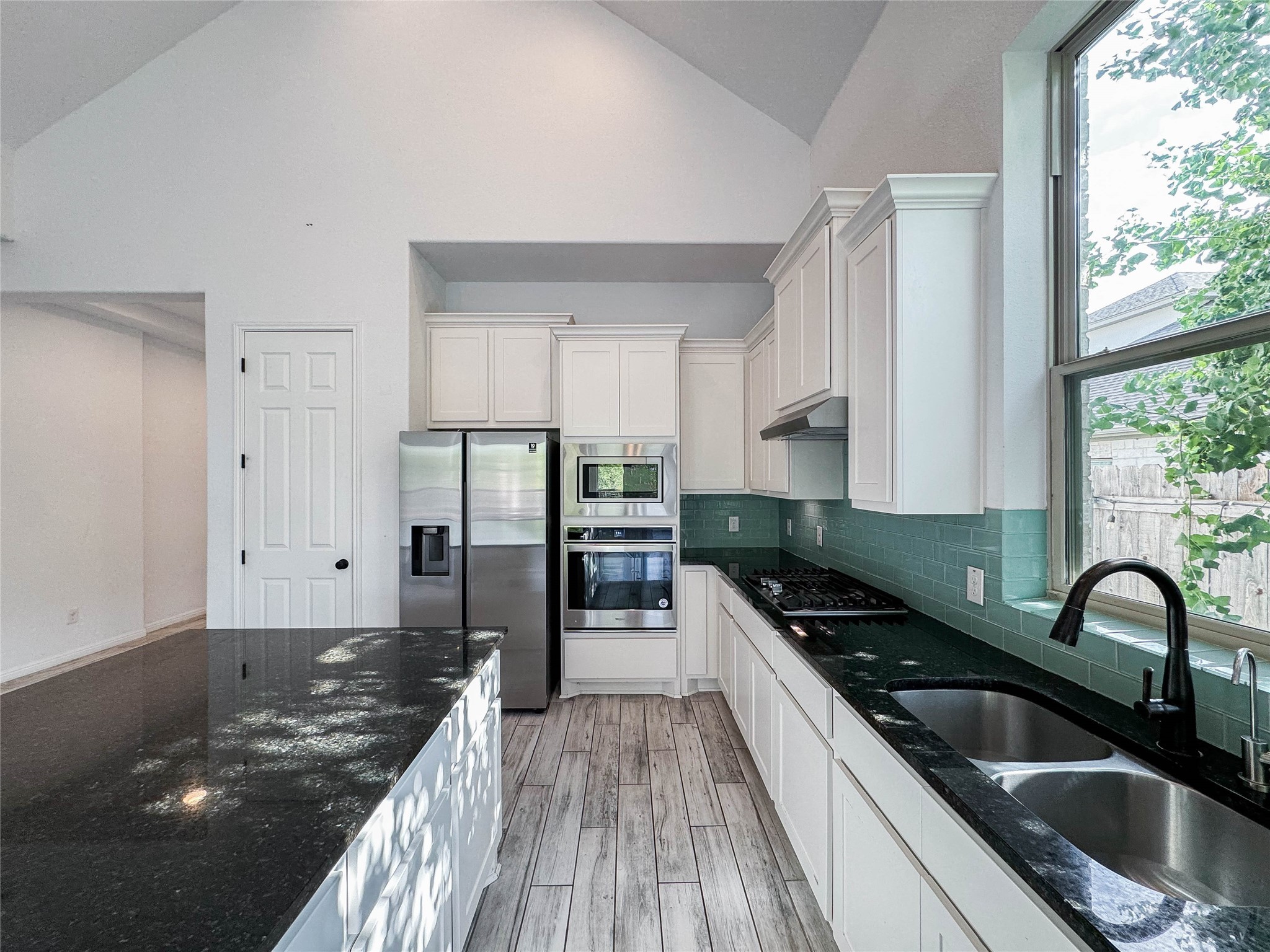 3810 Brushy Creek Road, Unit 73 Cedar Park, TX 78613 - Photo 8 of 42 a kitchen with granite countertop a stove a sink and a refrigerator