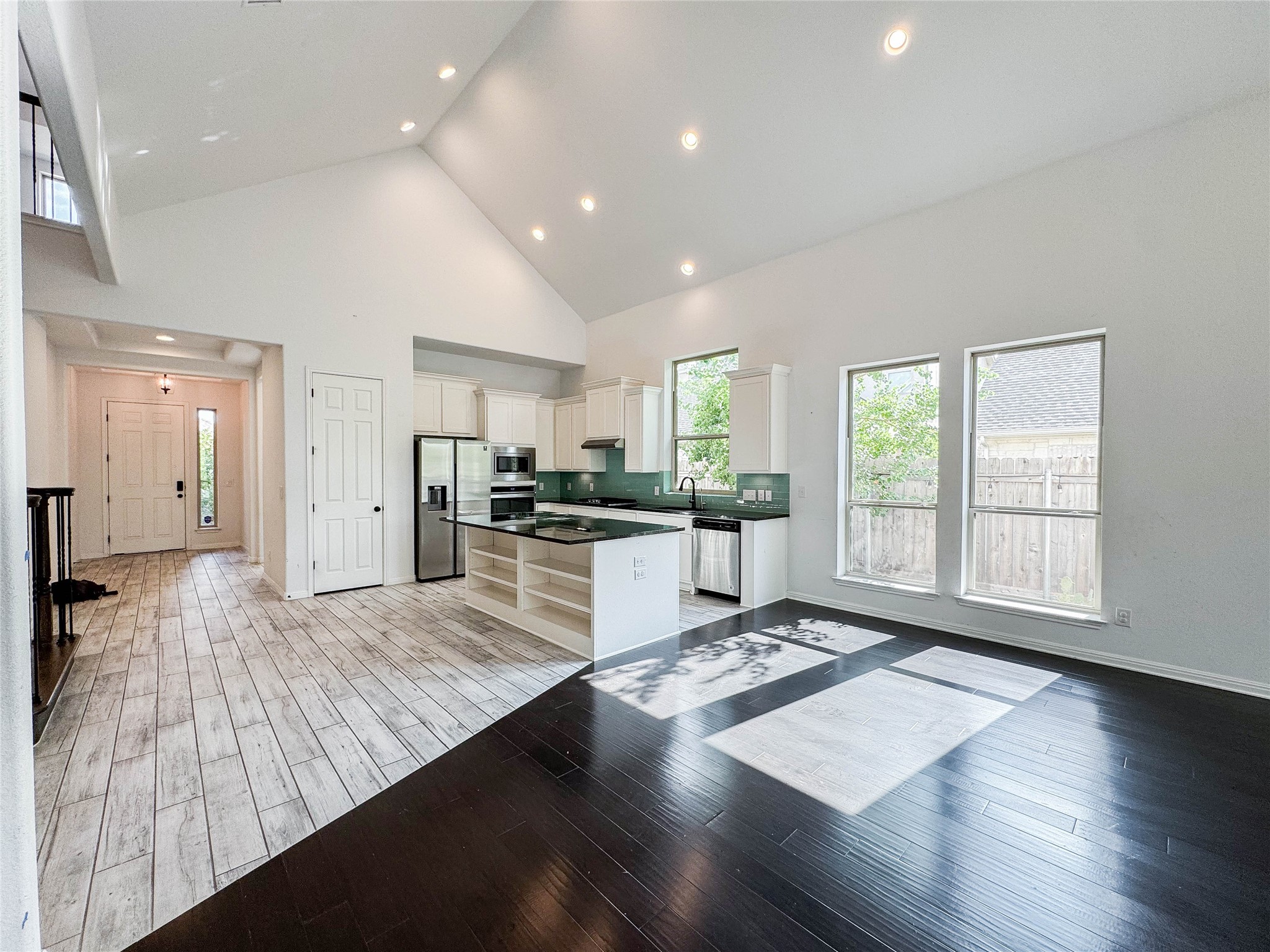 3810 Brushy Creek Road, Unit 73 Cedar Park, TX 78613 - Photo 10 of 42 a large open kitchen with kitchen island a refrigerator a stove a sink dishwasher and wooden cabinets with wooden floor
