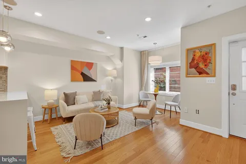a living room with furniture and wooden floor