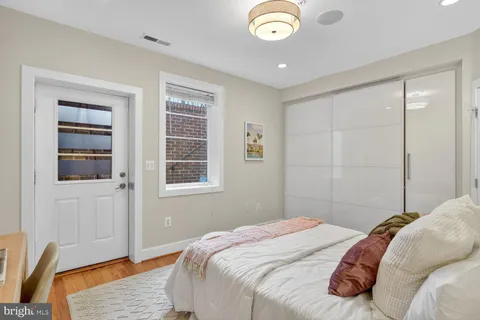 a bedroom with a bed and wooden floor