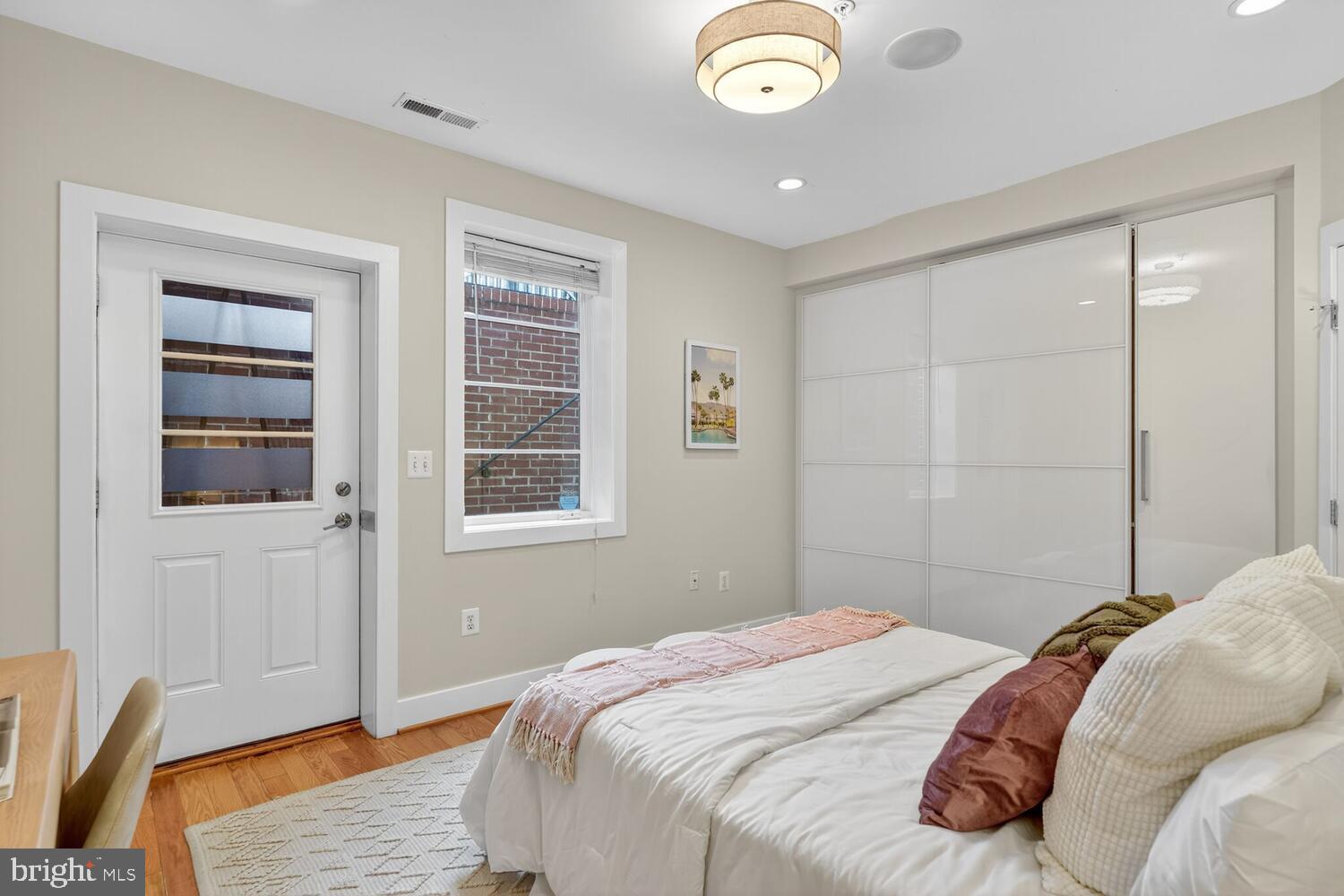 1306 8th Street Northwest, Unit 1 Washington, DC 20001 - Photo 15 of 19 a bedroom with a bed and wooden floor