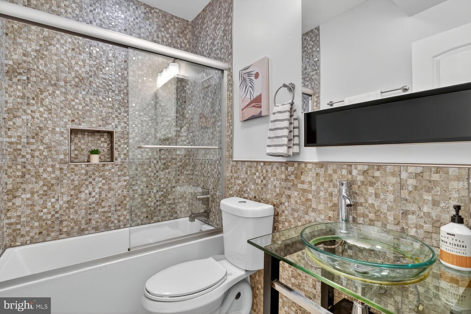 1306 8th Street Northwest, Unit 1 Washington, DC 20001 - Photo 16 of 19 a bathroom with a sink a toilet and shower