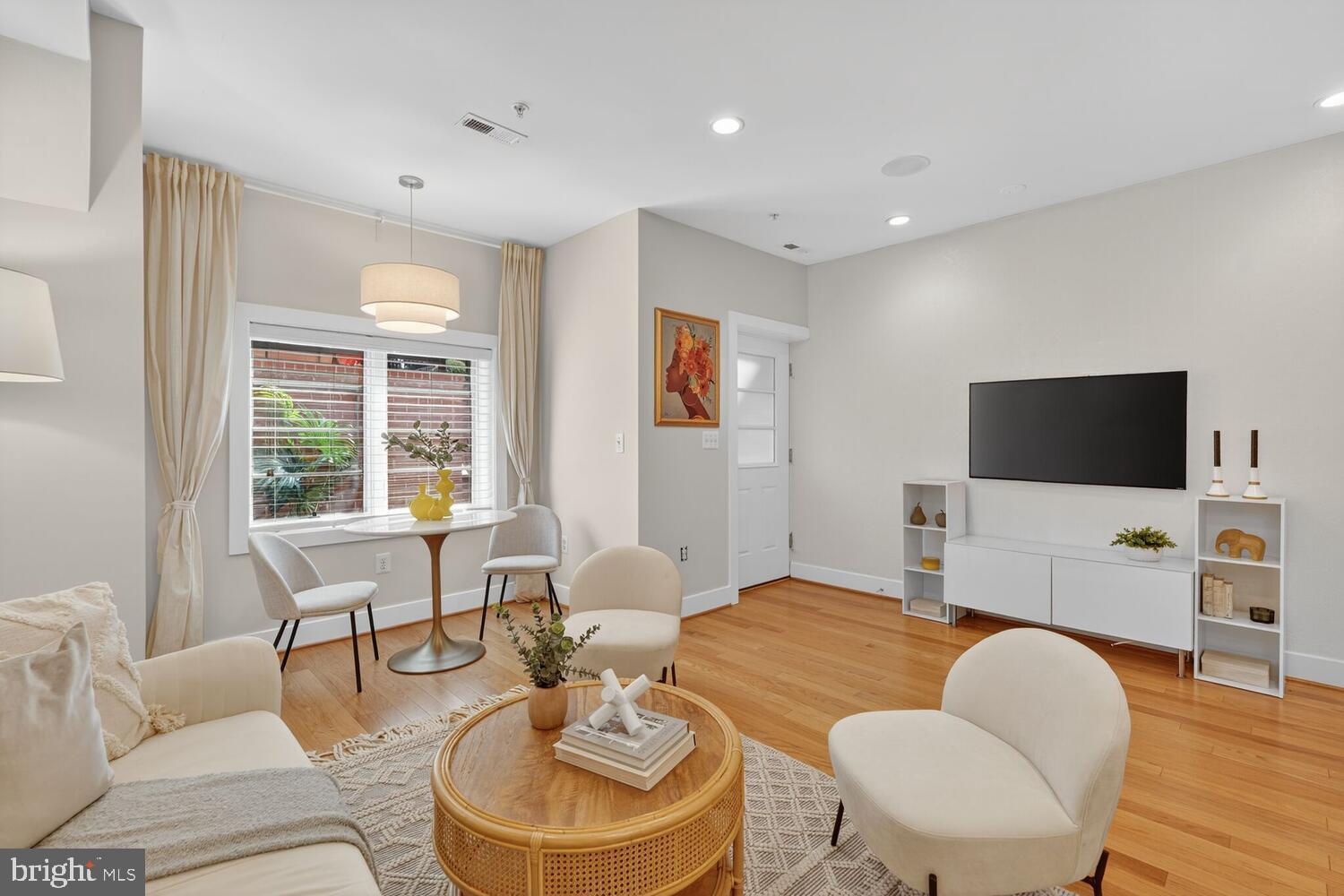 1306 8th Street Northwest, Unit 1 Washington, DC 20001 - Photo 4 of 19 a living room with furniture and a flat screen tv