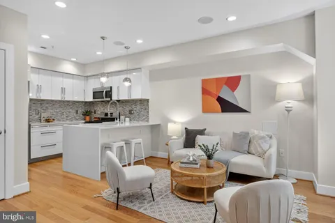 a living room with furniture and kitchen view
