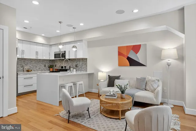 a living room with furniture and kitchen view