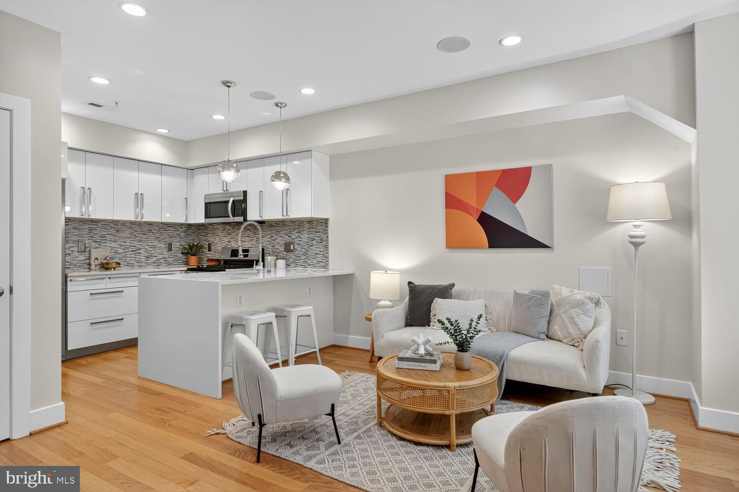 1306 8th Street Northwest, Unit 1 Washington, DC 20001 - Photo 5 of 19 a living room with furniture and kitchen view