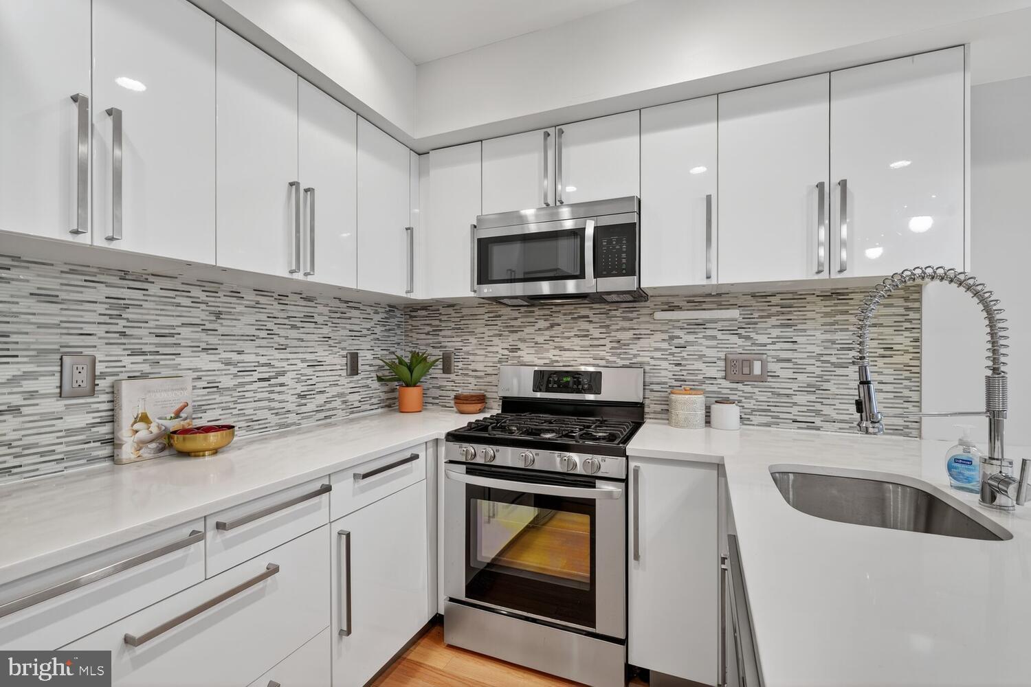 1306 8th Street Northwest, Unit 1 Washington, DC 20001 - Photo 8 of 19 a kitchen with a sink stove and microwave
