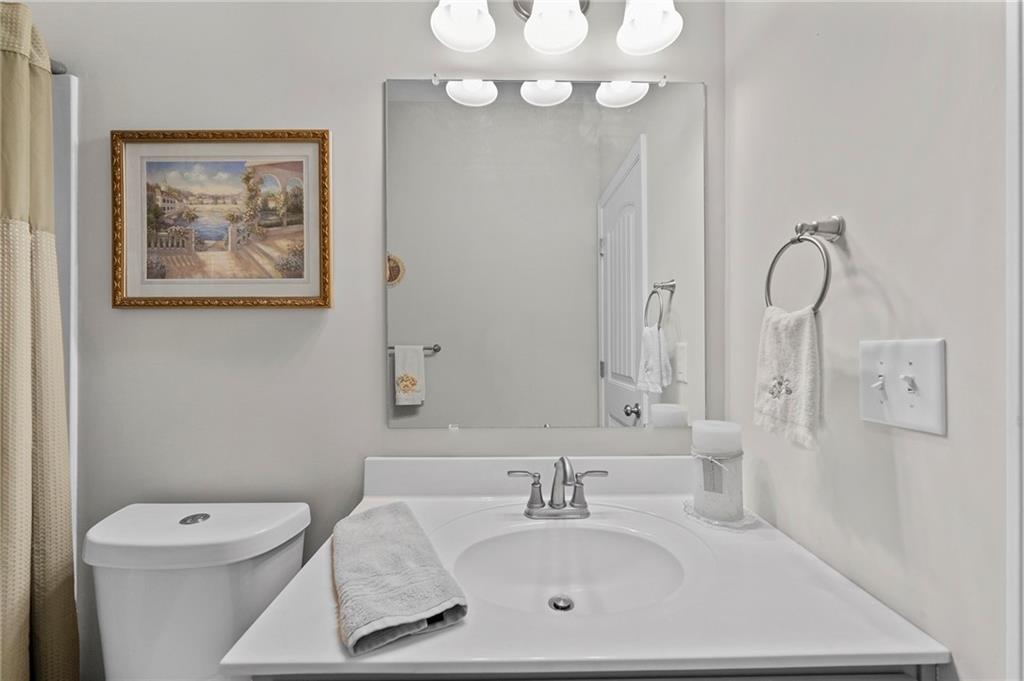 230 Augusta Walk Canton, GA 30114 - Photo 39 of 56 a bathroom with a sink a toilet and a mirror