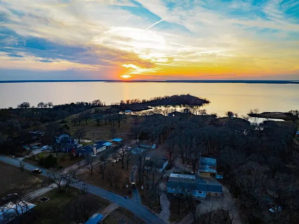 a view of a lake in middle of sunset