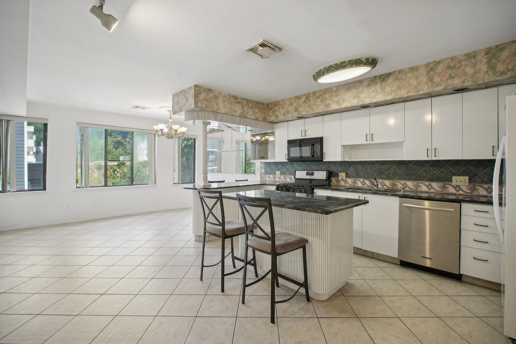 7 Grand Street Weehawken, NJ 07086 - Photo 3 of 16 a kitchen with stainless steel appliances granite countertop a stove a sink and a refrigerator