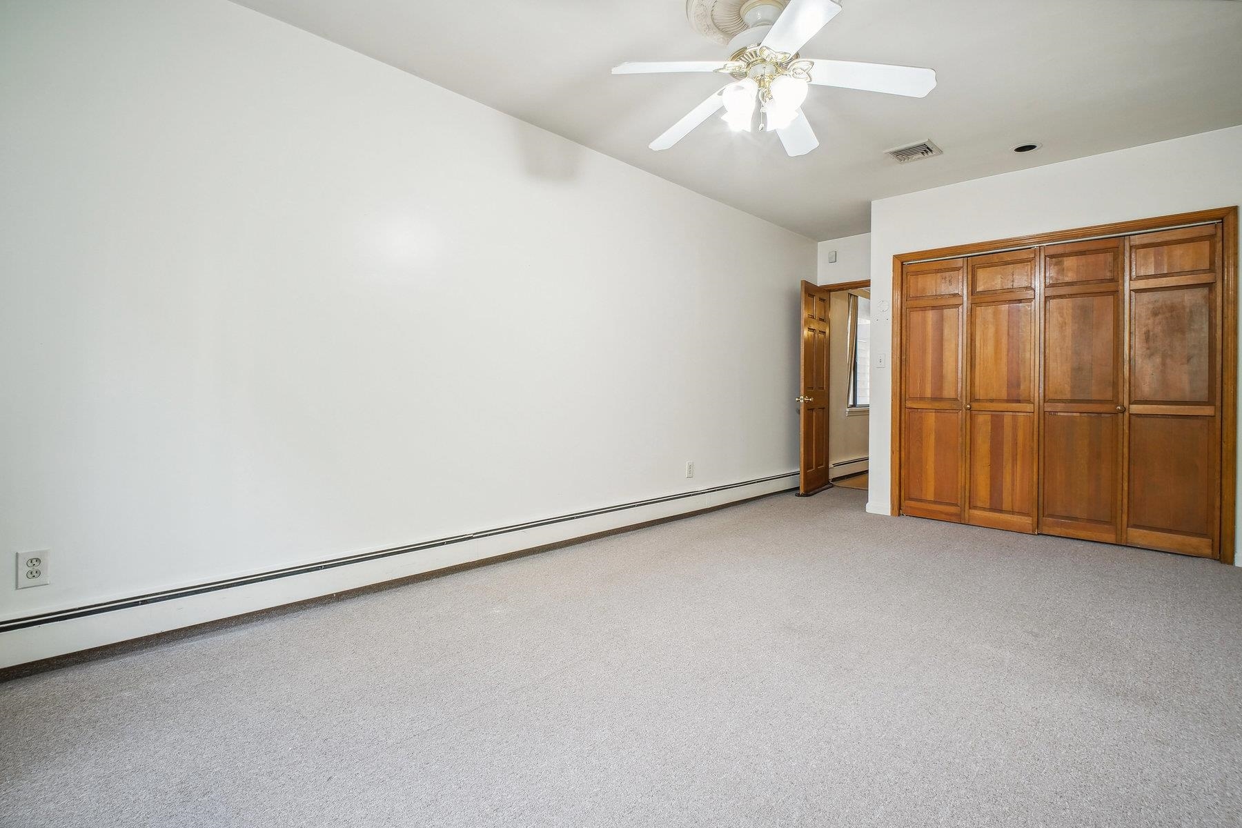 7 Grand Street Weehawken, NJ 07086 - Photo 7 of 16 an empty room with chandelier fan
