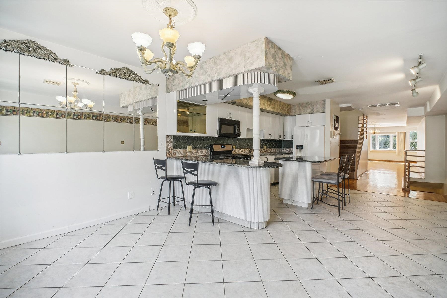7 Grand Street Weehawken, NJ 07086 - Photo 8 of 16 a large kitchen with a table and chairs