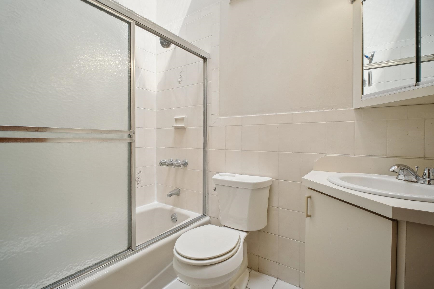 7 Grand Street Weehawken, NJ 07086 - Photo 9 of 16 a white toilet sitting next to a bathroom sink