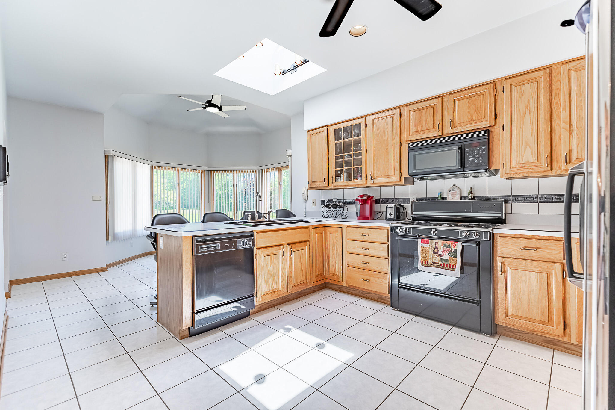 1020 Cornwallis Lane Munster, IN 46321 - Photo 17 of 41 a kitchen with stainless steel appliances granite countertop a stove a sink and a microwave