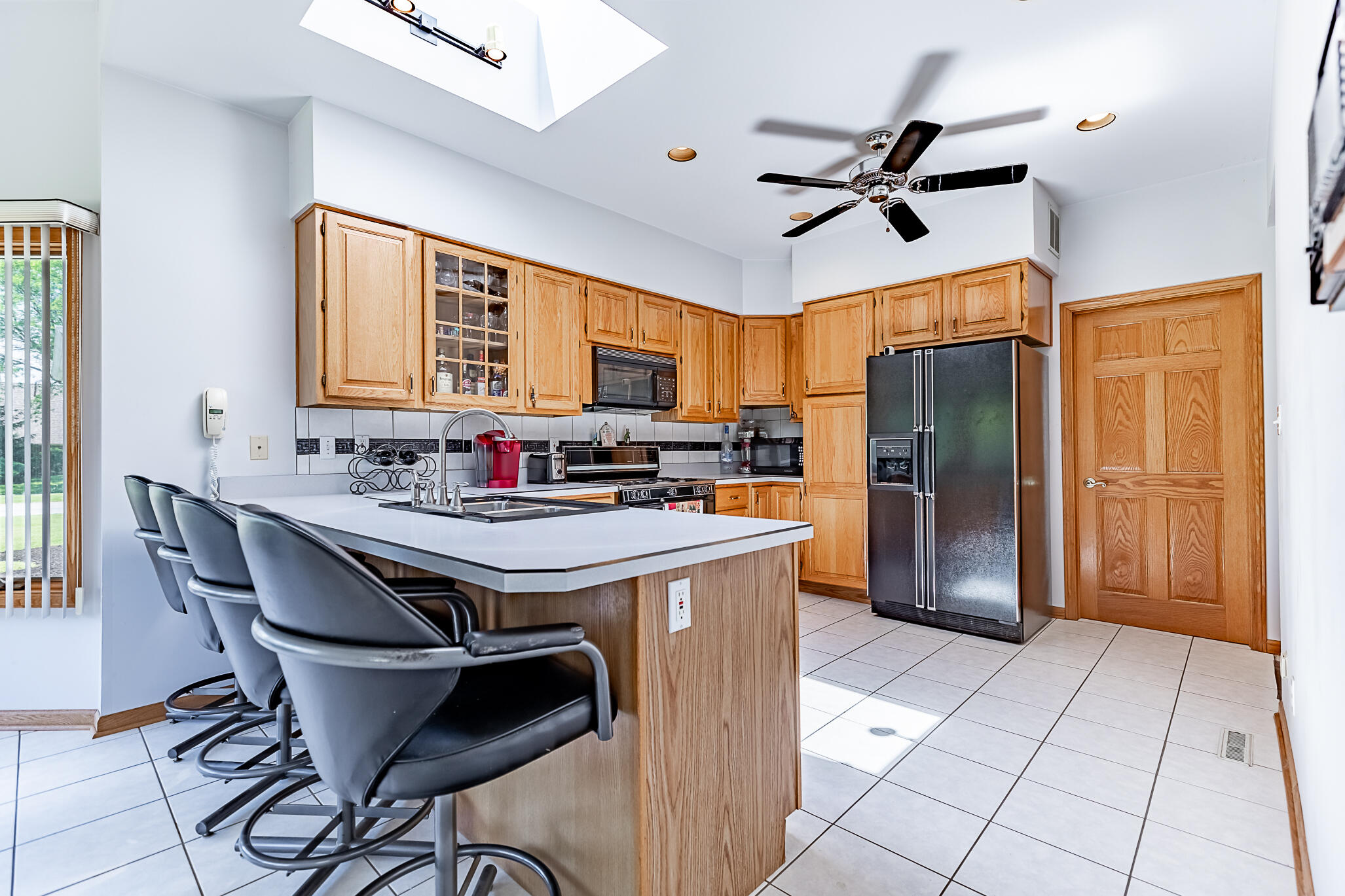 1020 Cornwallis Lane Munster, IN 46321 - Photo 18 of 41 a kitchen with stainless steel appliances granite countertop a sink a stove a refrigerator and a refrigerator