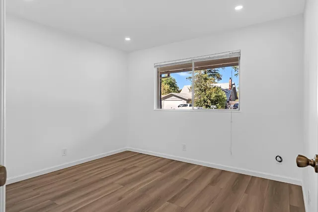 a view of room with wooden floor and fan