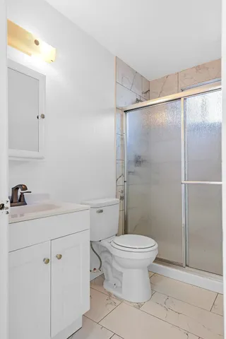 a bathroom with a sink toilet and shower