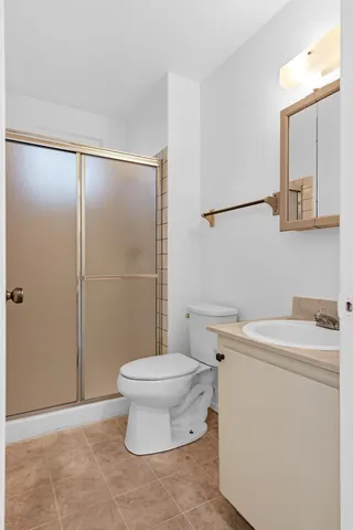 a white toilet sitting next to a bathroom sink