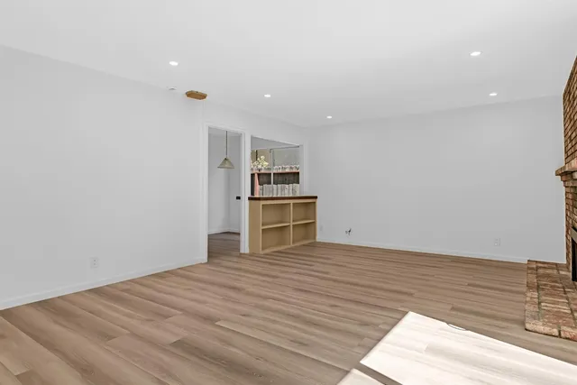 a view of a kitchen with wooden floor and kitchen