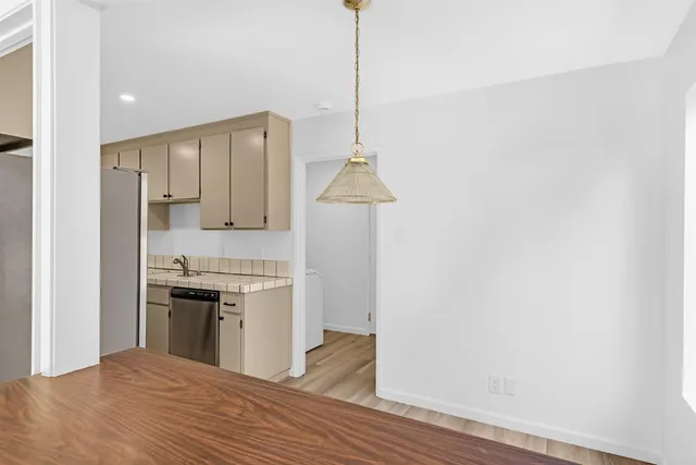 a kitchen with a stove and a wooden floor