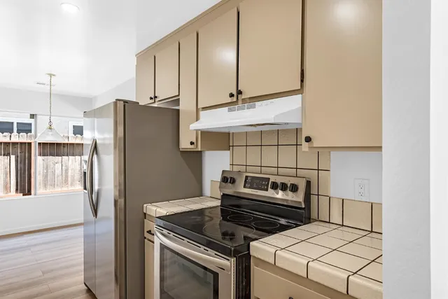 a kitchen with appliances and cabinets