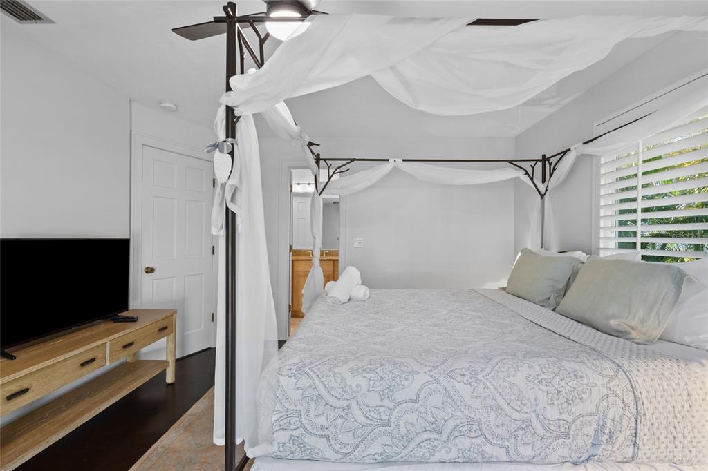 315 Spring Avenue Anna Maria, FL 34216 - Photo 28 of 63 a bedroom with a bed and a flat tv screen on a dresser