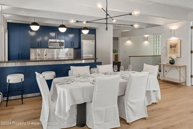 a view of a bedroom with a bed and a painting on the wall