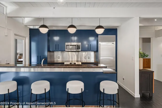 a kitchen with granite countertop a sink and stove