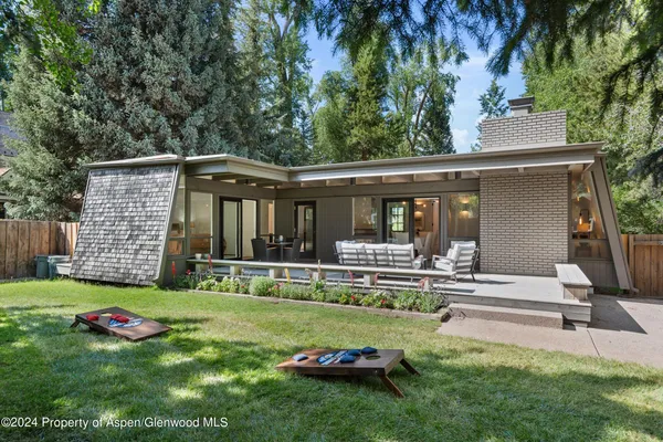 a view of a house with backyard porch and sitting area