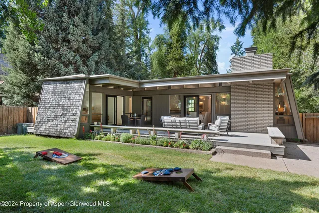 a view of a house with backyard porch and sitting area