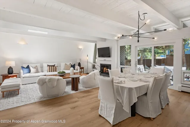 a living room with fireplace furniture and a large window