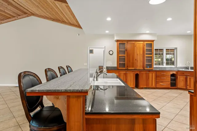 a large bathroom with a double vanity sink a large mirror and a bathtub