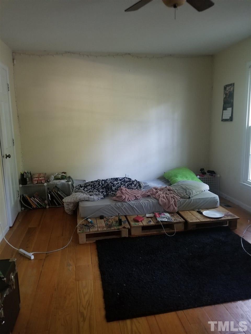 620 Brent Road Raleigh, NC 27606 - Photo 5 of 8 a bed sitting in a bedroom next to a window