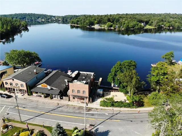 an aerial view of a house with garden space and lake view