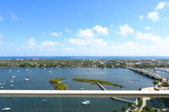 a living room with furniture a flat screen tv and a chandelier