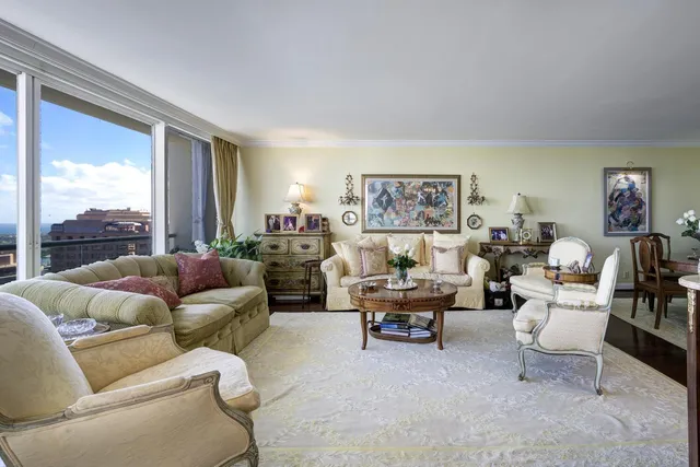 a view of living room kitchen with stainless steel appliances granite countertop furniture and fireplace