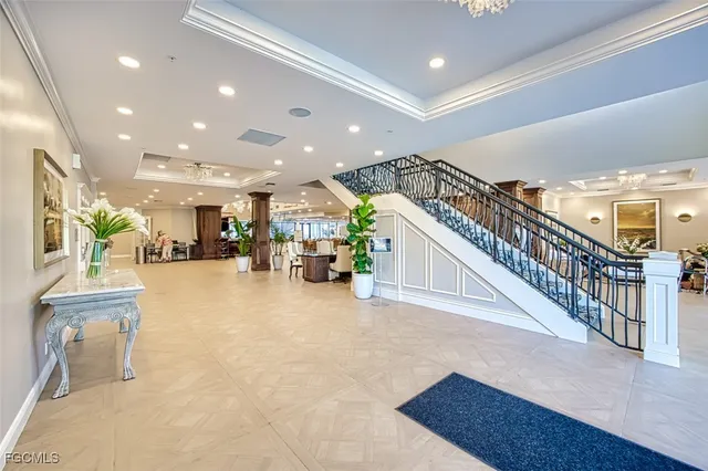 a large room with lots of white furniture