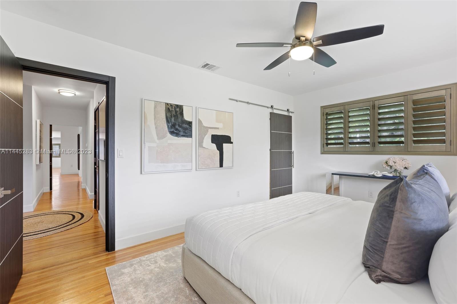 3411 Riviera Drive Coral Gables, FL 33134 - Photo 22 of 38 a spacious bedroom with a bed and ceiling fan