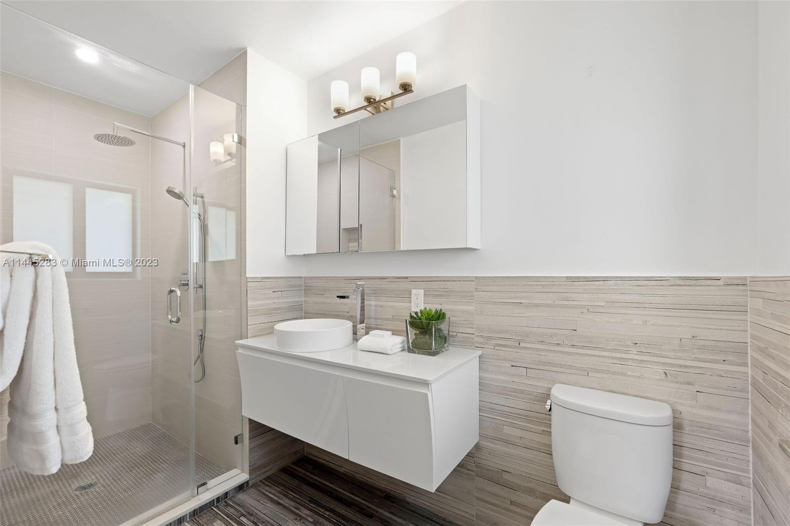 3411 Riviera Drive Coral Gables, FL 33134 - Photo 23 of 38 a bathroom with a sink a toilet and shower