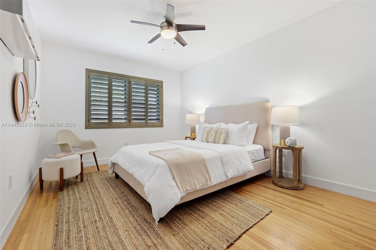 3411 Riviera Drive Coral Gables, FL 33134 - Photo 25 of 38 a bedroom with a bed wooden floor and window